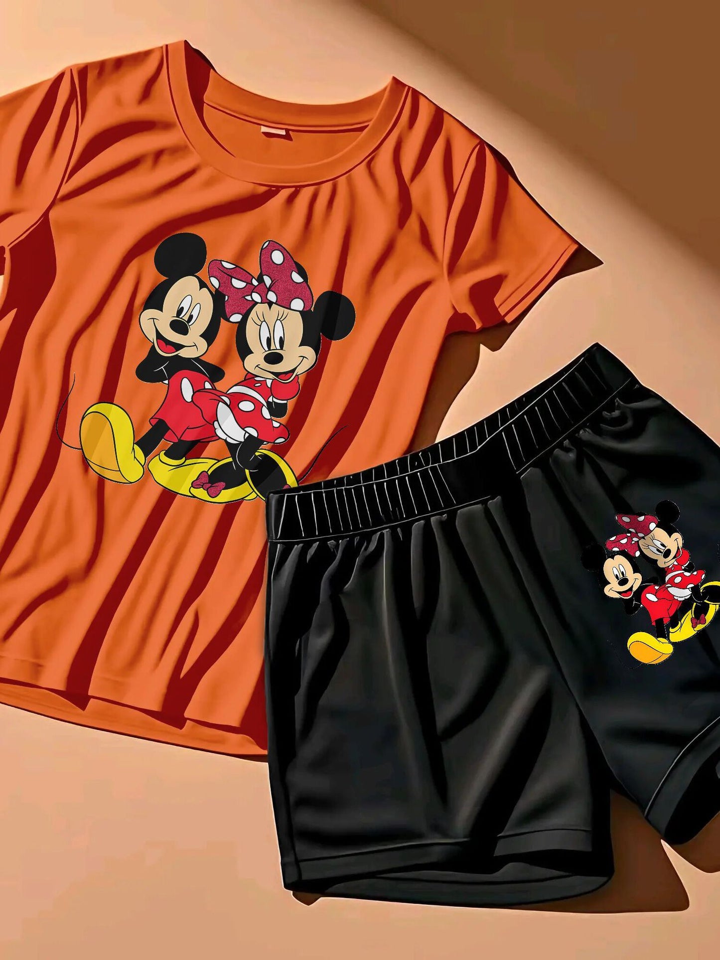 A Two-Piece Outfit Featuring a Printed Short-Sleeve T-Shirt with Dropped Shoulders And Cropped Leggings, Designed for Plus-Size Women, Licensed with Mickey And Minnie.